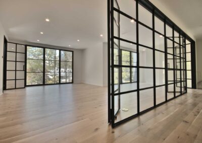 Second-floor-family-room-with-a-steel-glass-wall-and-modern-steel-doors